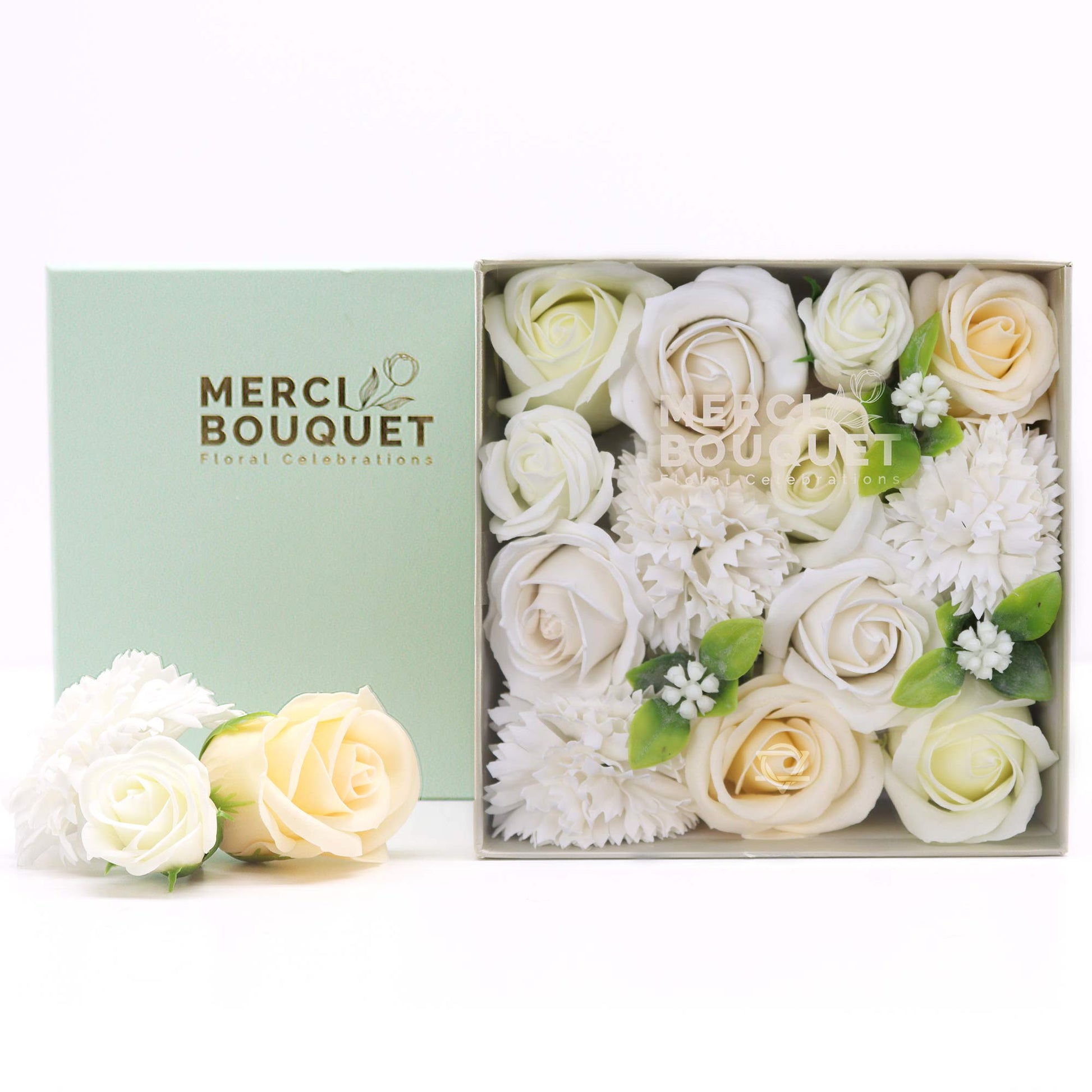 Box of Merci Bouquet with white and cream flowers on a white background