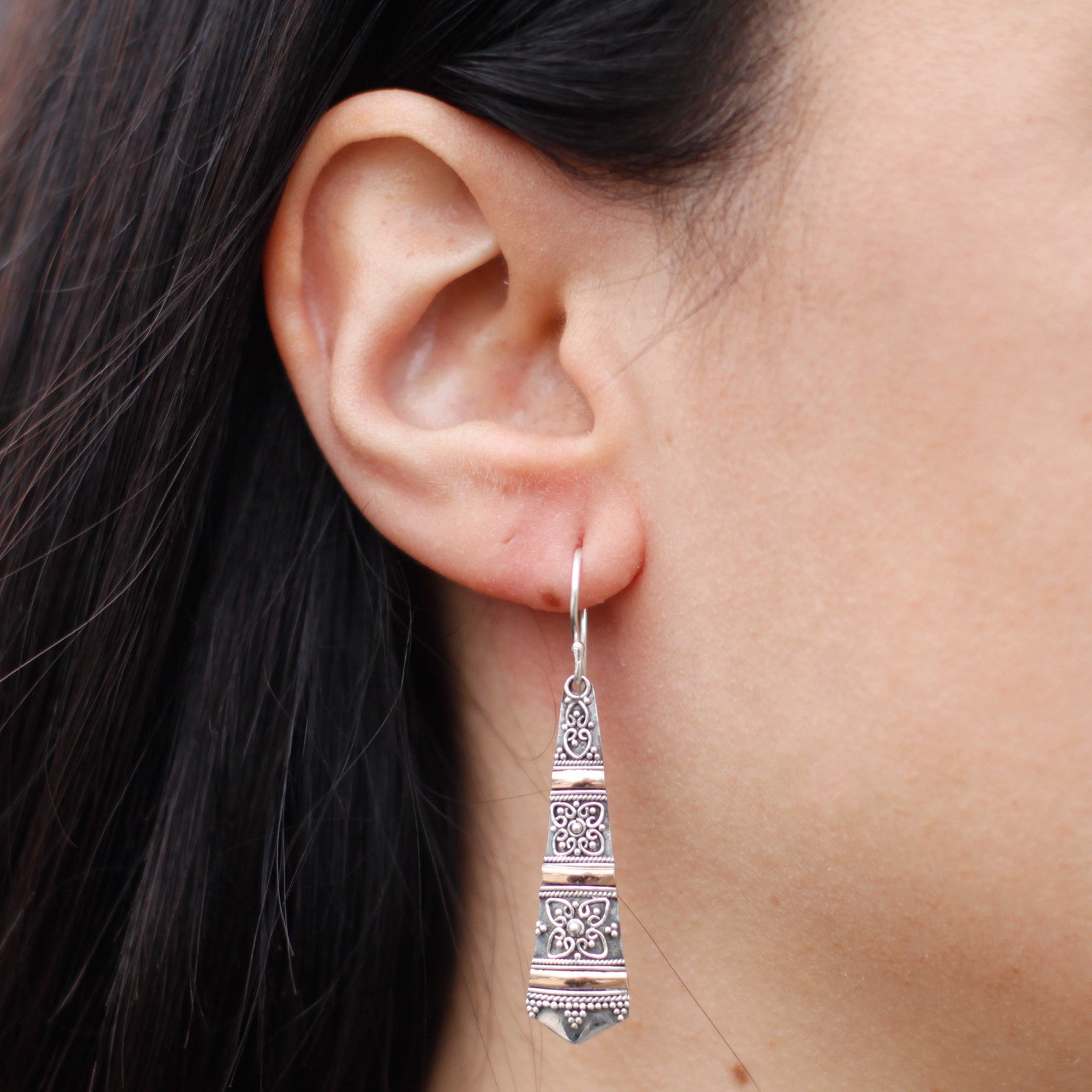 ear shot of earing Silver & Gold Earring - Tribal Drops Specifications: - Height with Drop: 3.2cm - Fitting: Hook - Metal: 18k Gold & 925 Silver - Weight: 3 grams (combined)