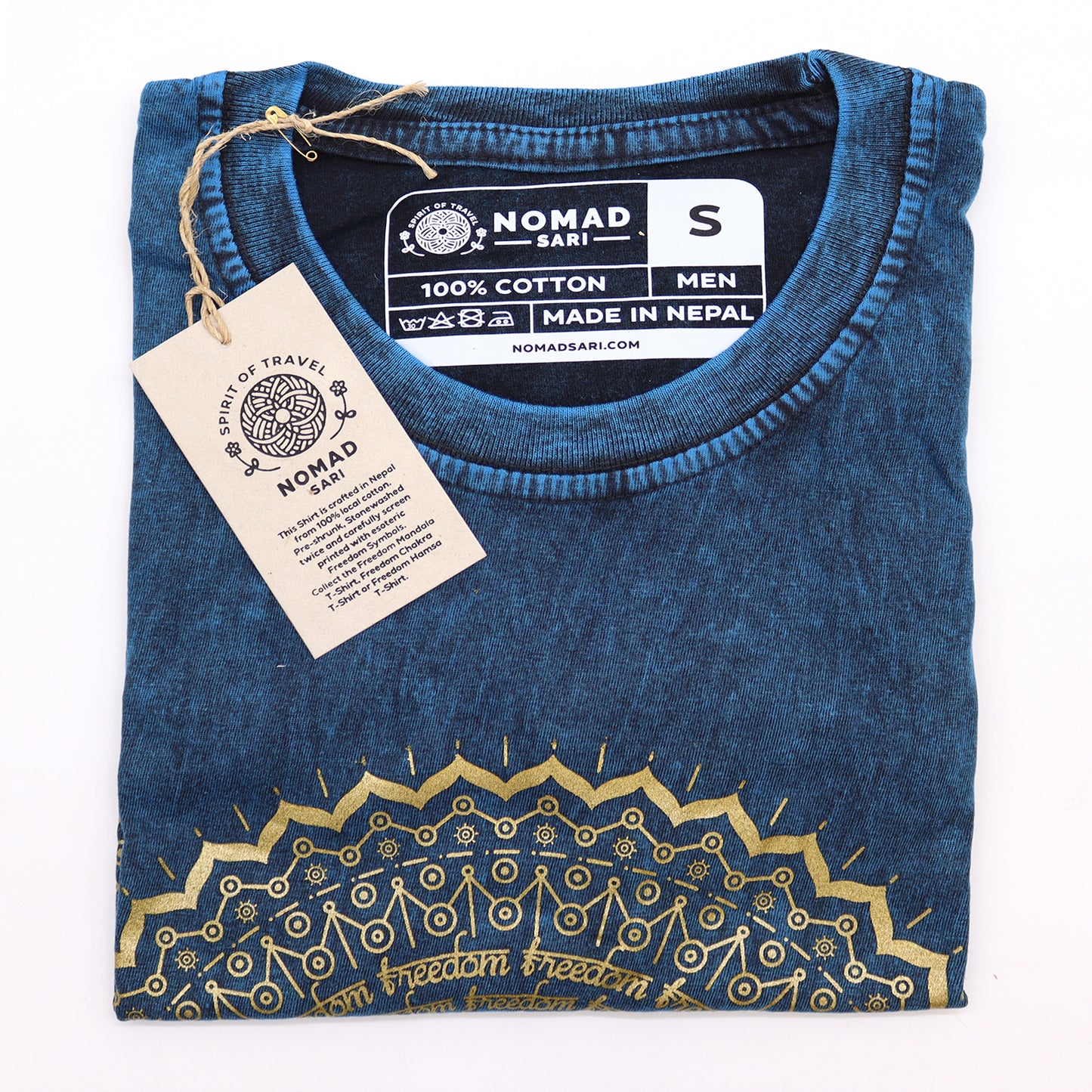 Folded blue t-shirt with gold design and 'Nomad Sari' label on a white background