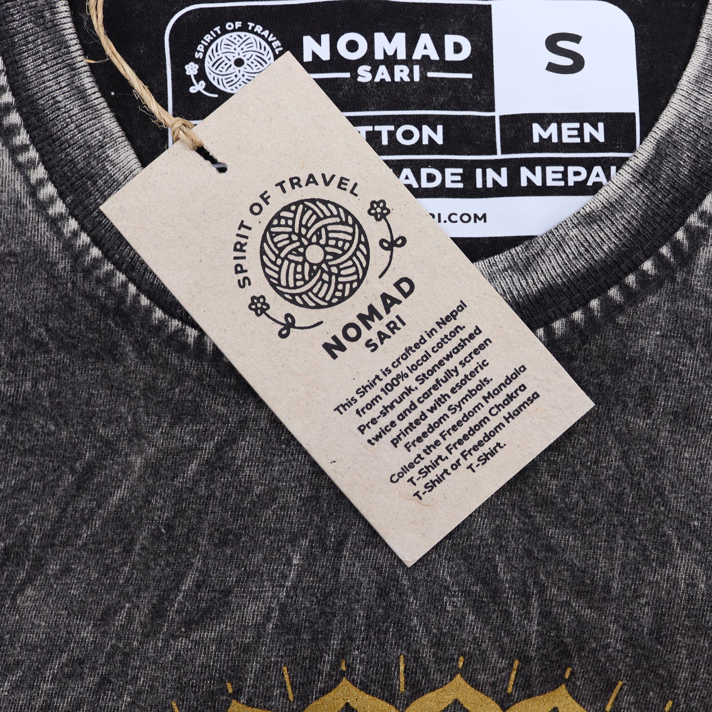 Close-up of a tag on a garment with 'Nomad Sari' branding.