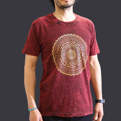 Maroon t-shirt with a gold mandala design worn by a person on a dark background
