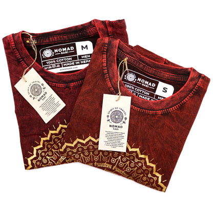 2 Folded red shirts with gold patterns and 'Nomad' labels on a white background