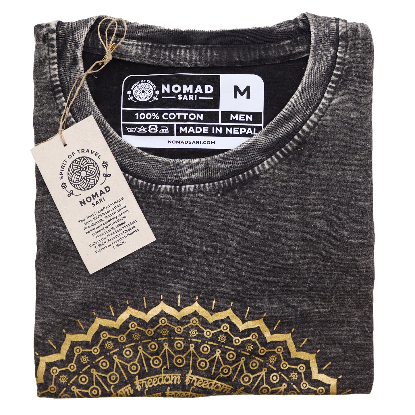 Folded black t-shirt with gold patterns and a visible tag on a white background
