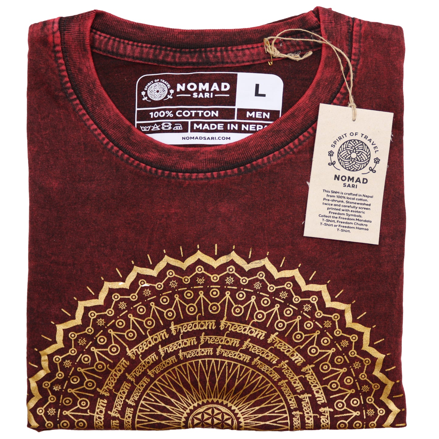 Folded maroon t-shirt with gold design and 'Nomad Sari' label on a white background