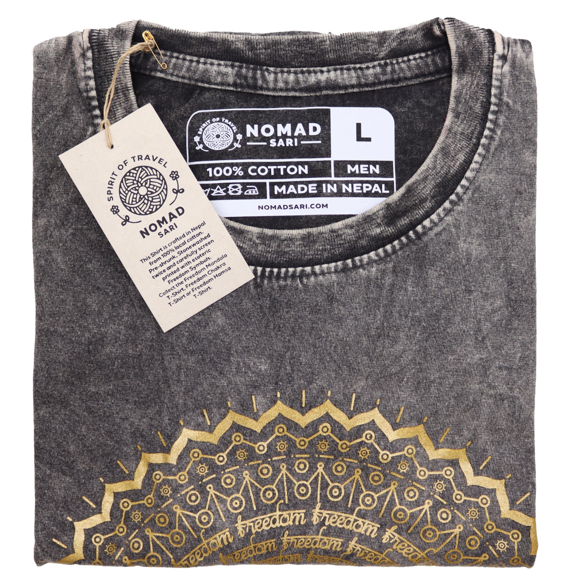 Folded black t-shirt with gold embroidery and 'Nomad Sari' label on a white background