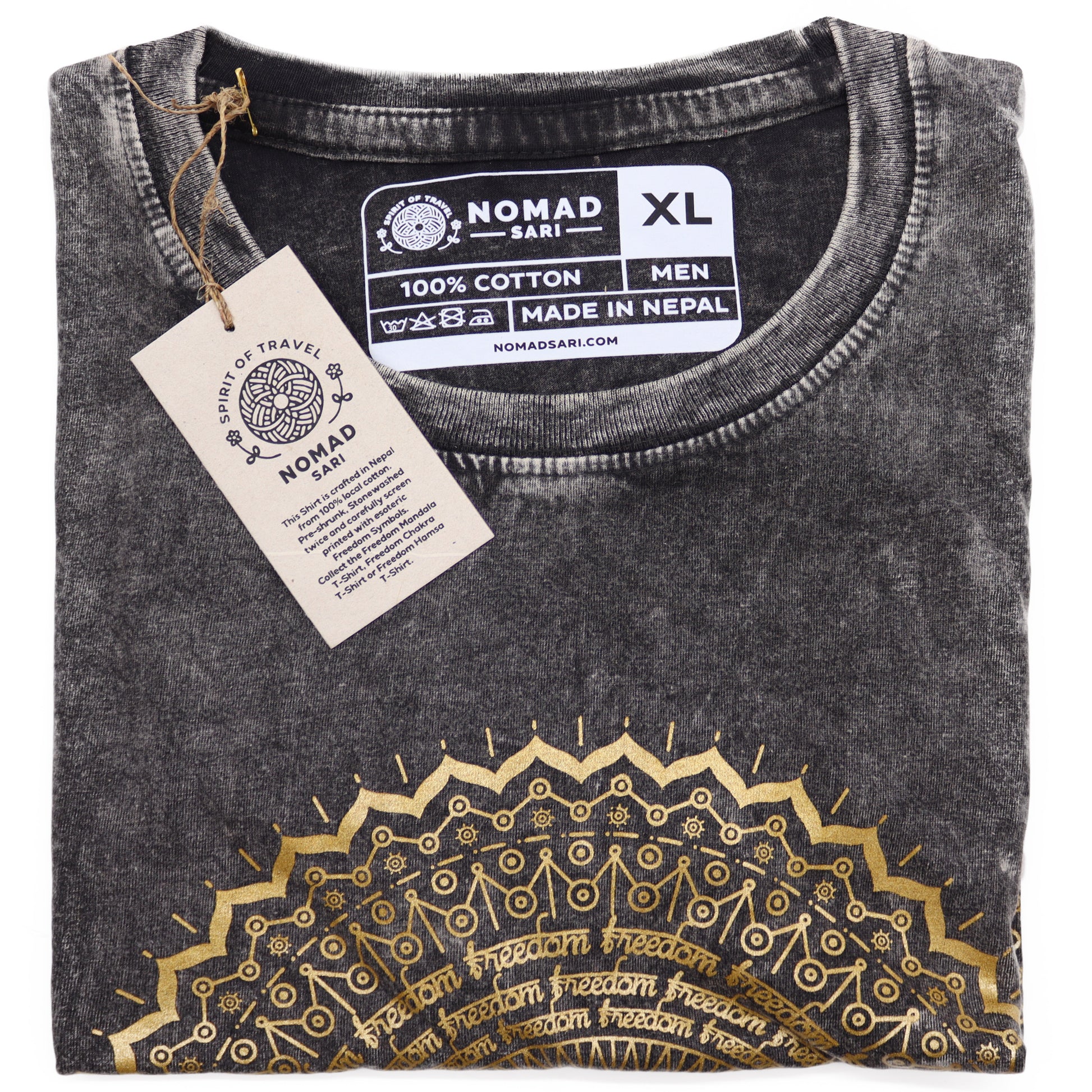 Folded black t-shirt with gold embroidery and 'Nomad Sari' label on a white background