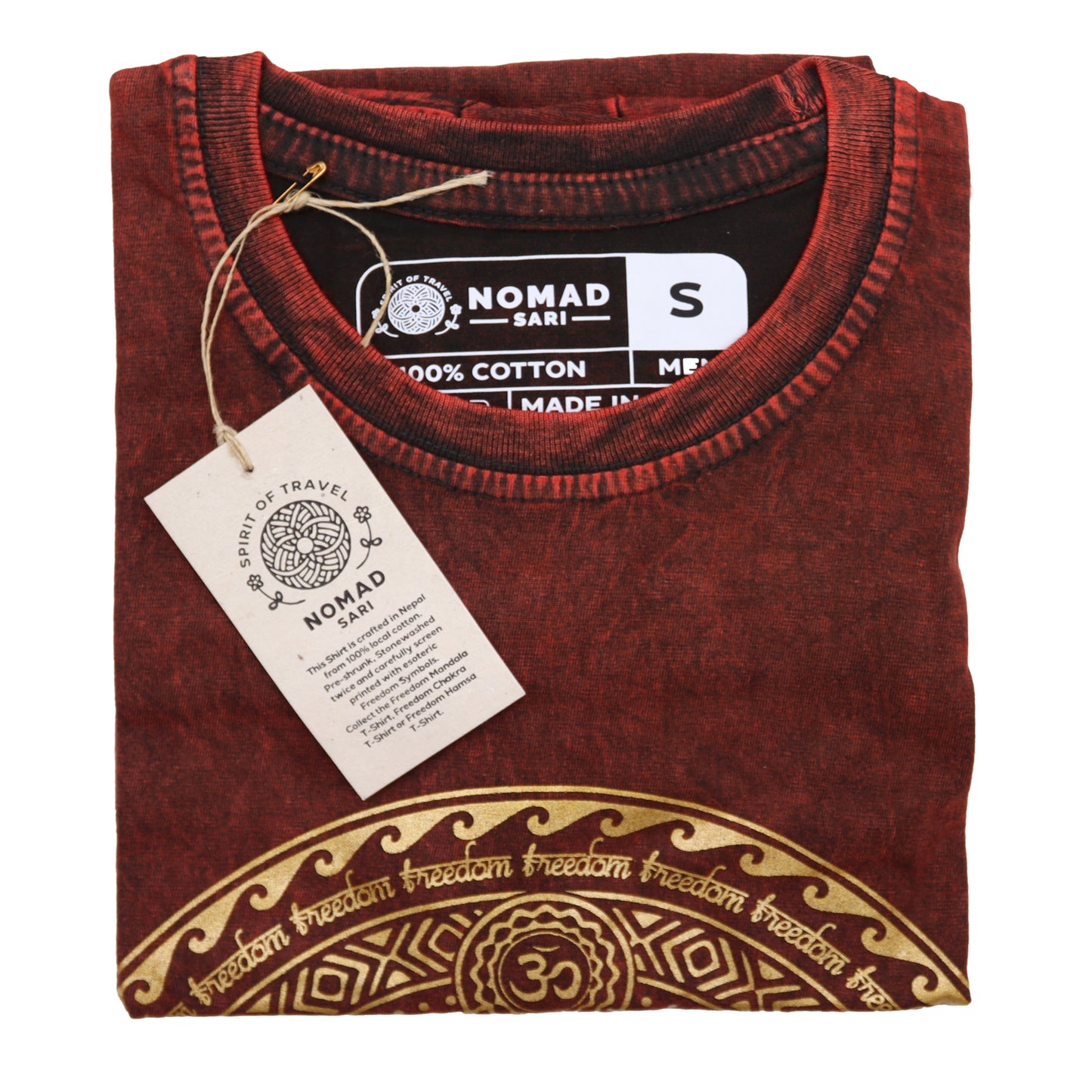 Folded maroon t-shirt with gold design and 'Nomad Sari' tag on a white background