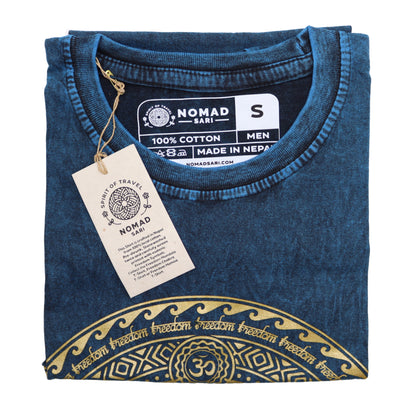Folded blue t-shirt with gold design and 'Nomad Sari' tag on a white background