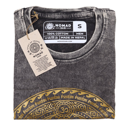 Folded gray t-shirt with gold design and 'Nomad Sari' label on a white background