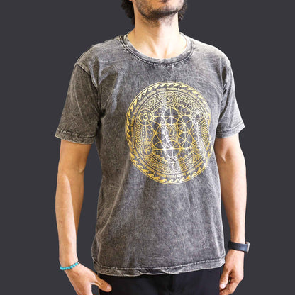 Person wearing a watch&  gray short sleeved t-shirt with a gold geometric Chakra  design on a dark background