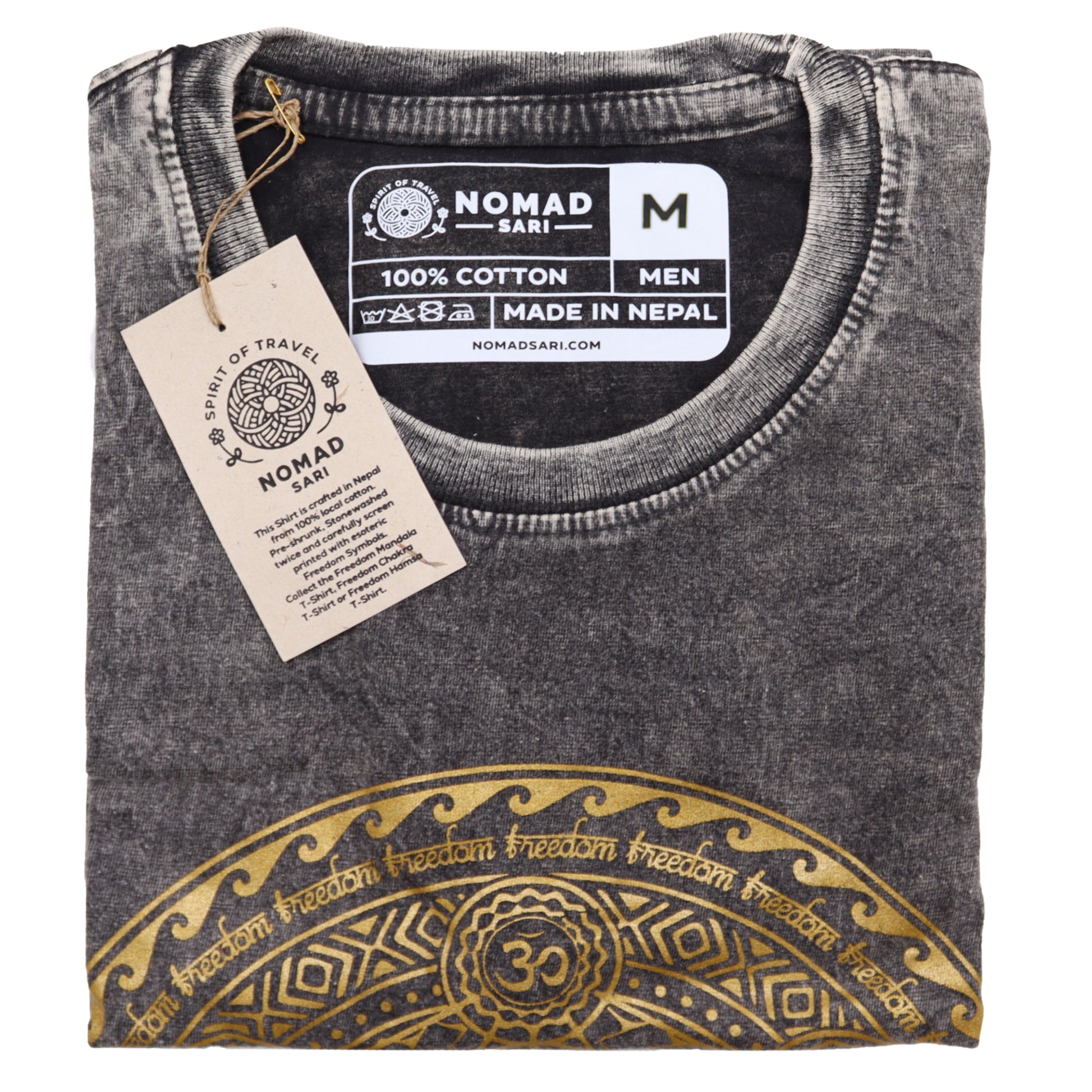 Folded gray t-shirt with gold design and Nomad Sari label on a white background