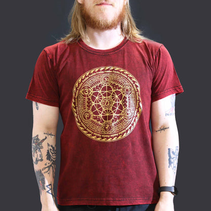 Person wearing a red t-shirt with a gold circular design on a dark background