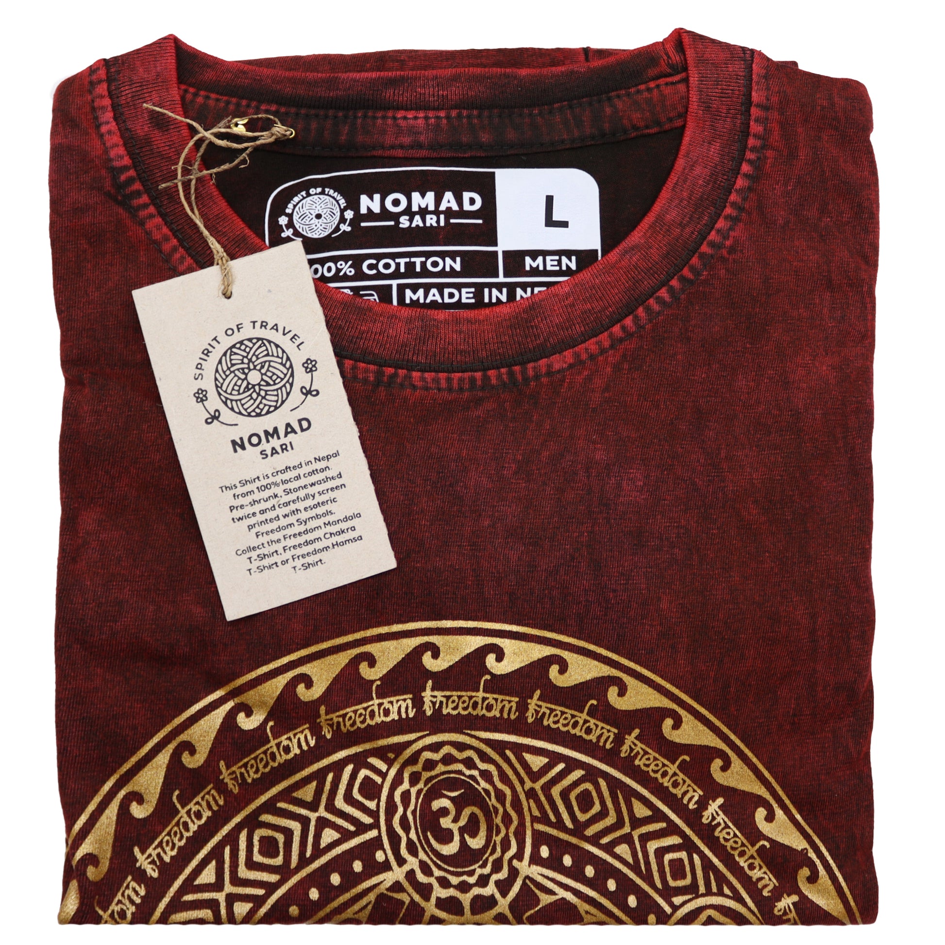 Folded maroon t-shirt with gold design and 'Nomad Sari' label on a white background