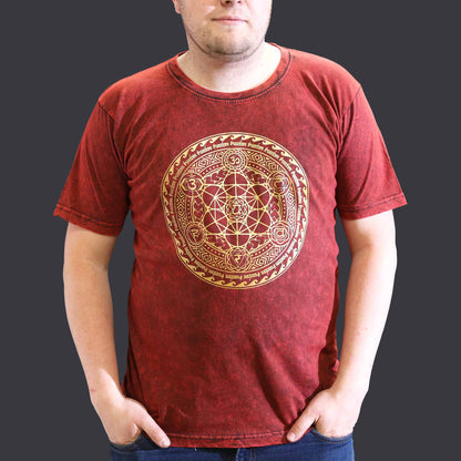 Person wearing a red t-shirt with a gold geometric design on a dark background