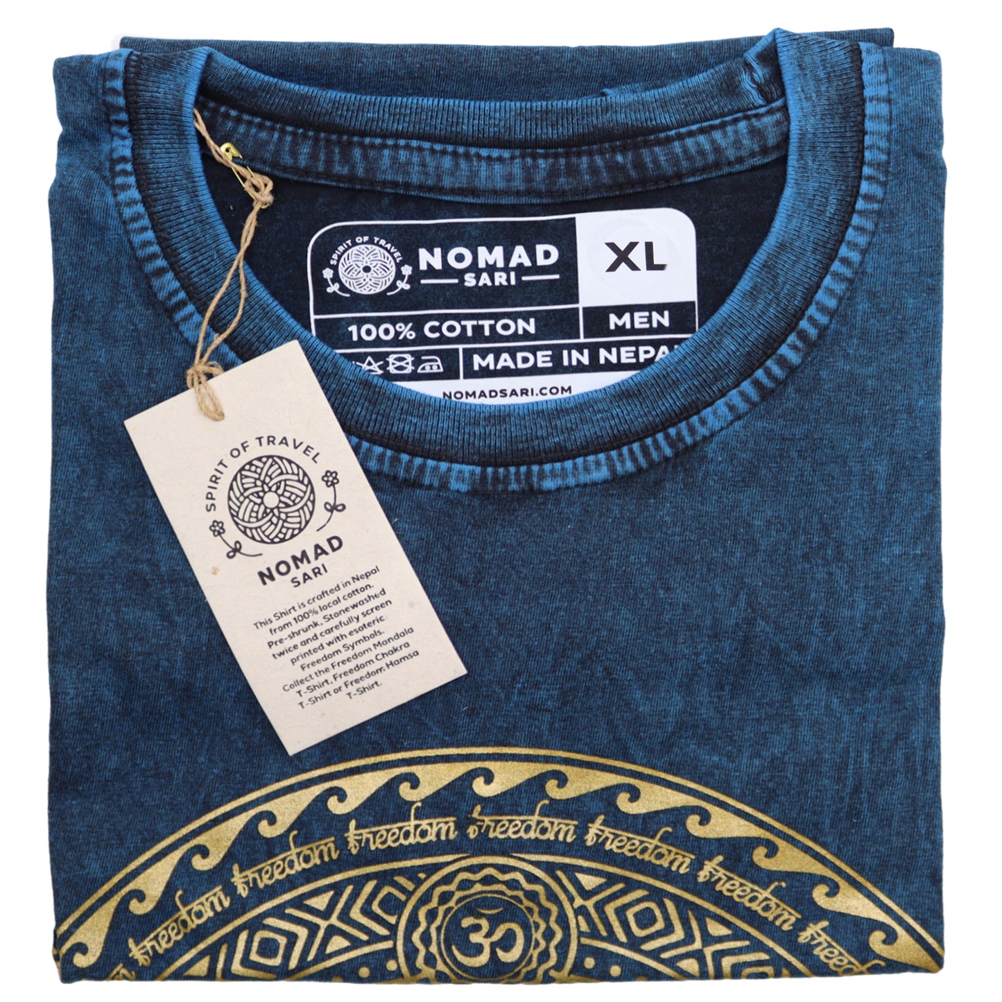 Folded blue t-shirt with gold design and Nomad Sari tag on a white background