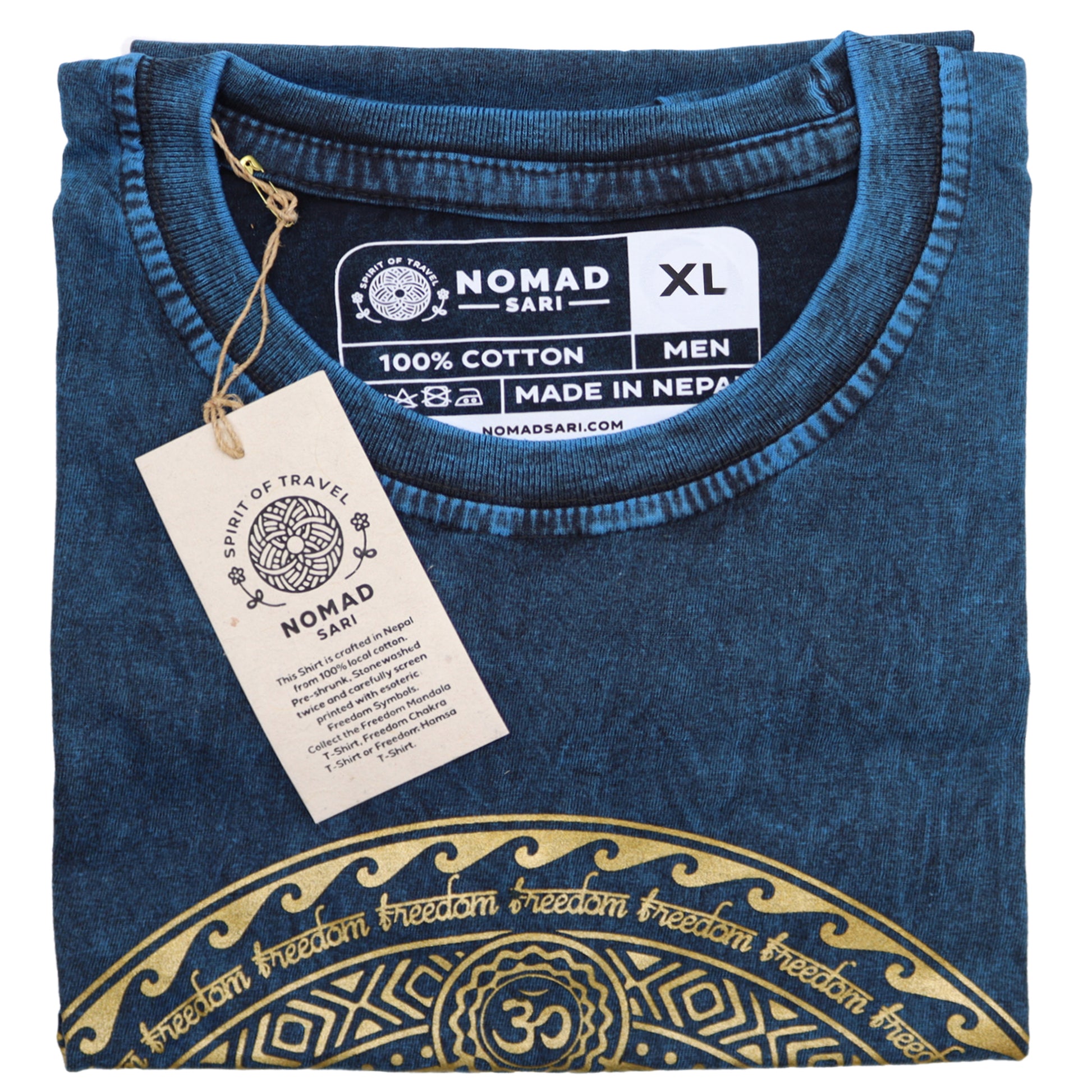 Folded blue t-shirt with gold design and Nomad Sari tag on a white background