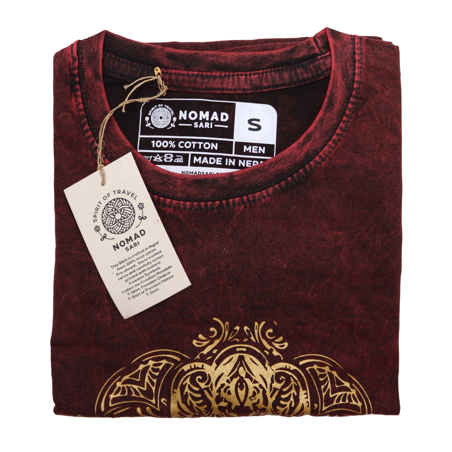 Folded maroon t-shirt with gold design and Nomad label on a white background