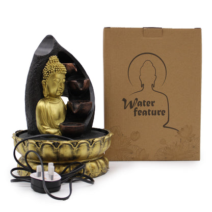 Buddha-themed water feature with packaging on a white background