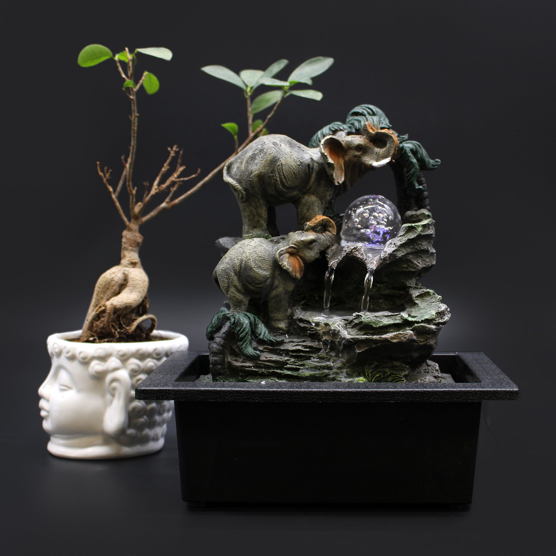 Tabletop Water Feature - 30cm - Elephant Family and a crystal ball on a dark background
