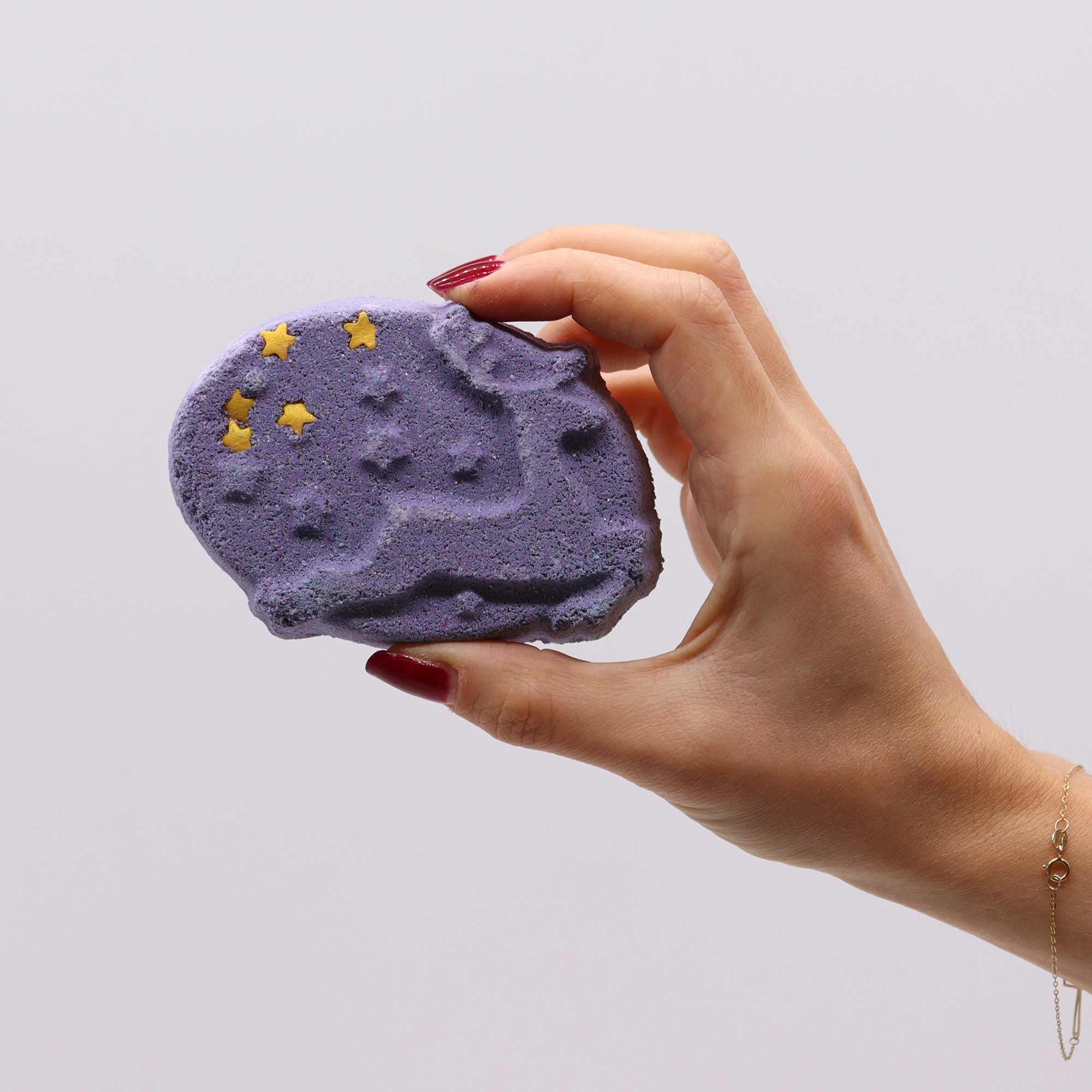 hand holding a reindeer bar of purple soap