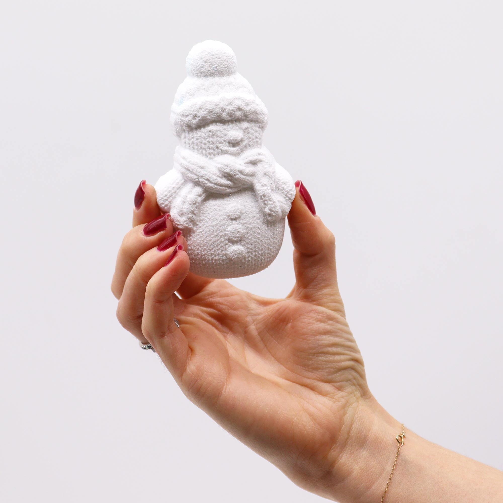 hand holding white snowman bar of soap