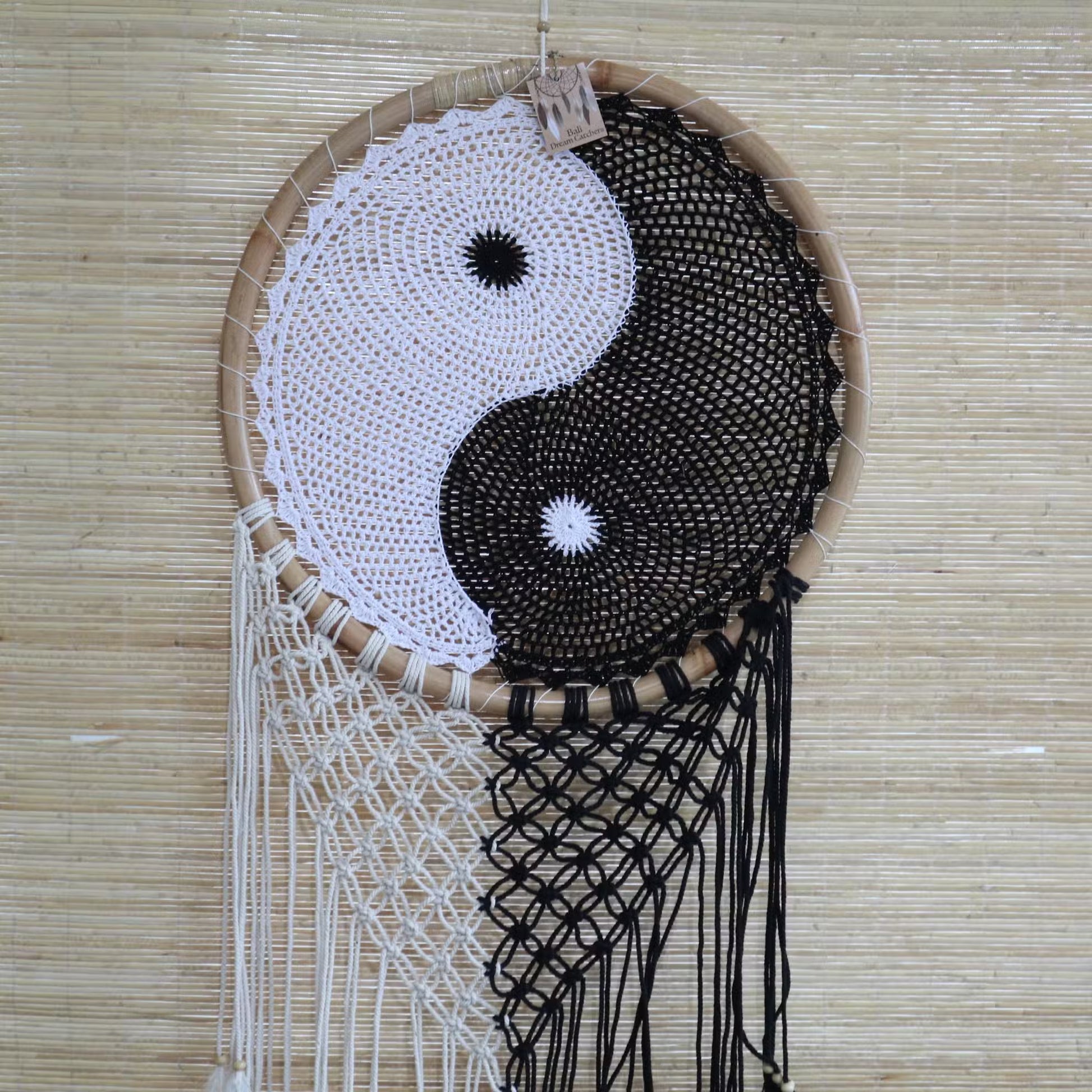 Dreamcatcher with yin yang design on a woven background