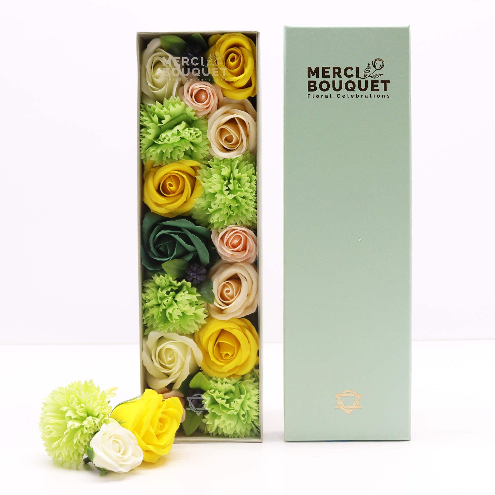 Colorful flowers in a Merci Bouquet box on a white background