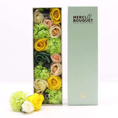 Colorful flowers in a Merci Bouquet box on a white background